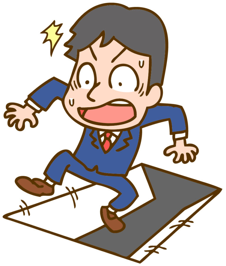 落とし穴に落ちそうな男性