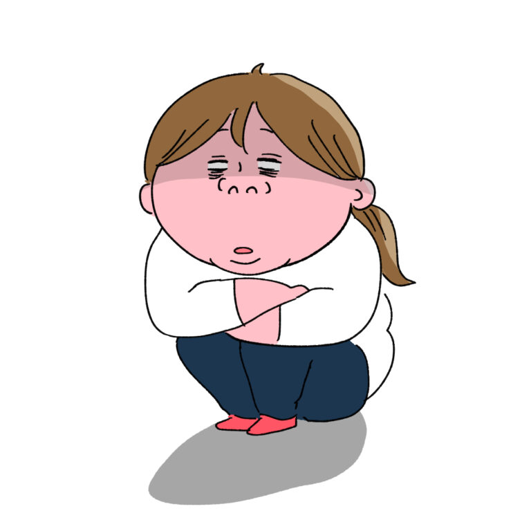体育座りで放心状態の女性
